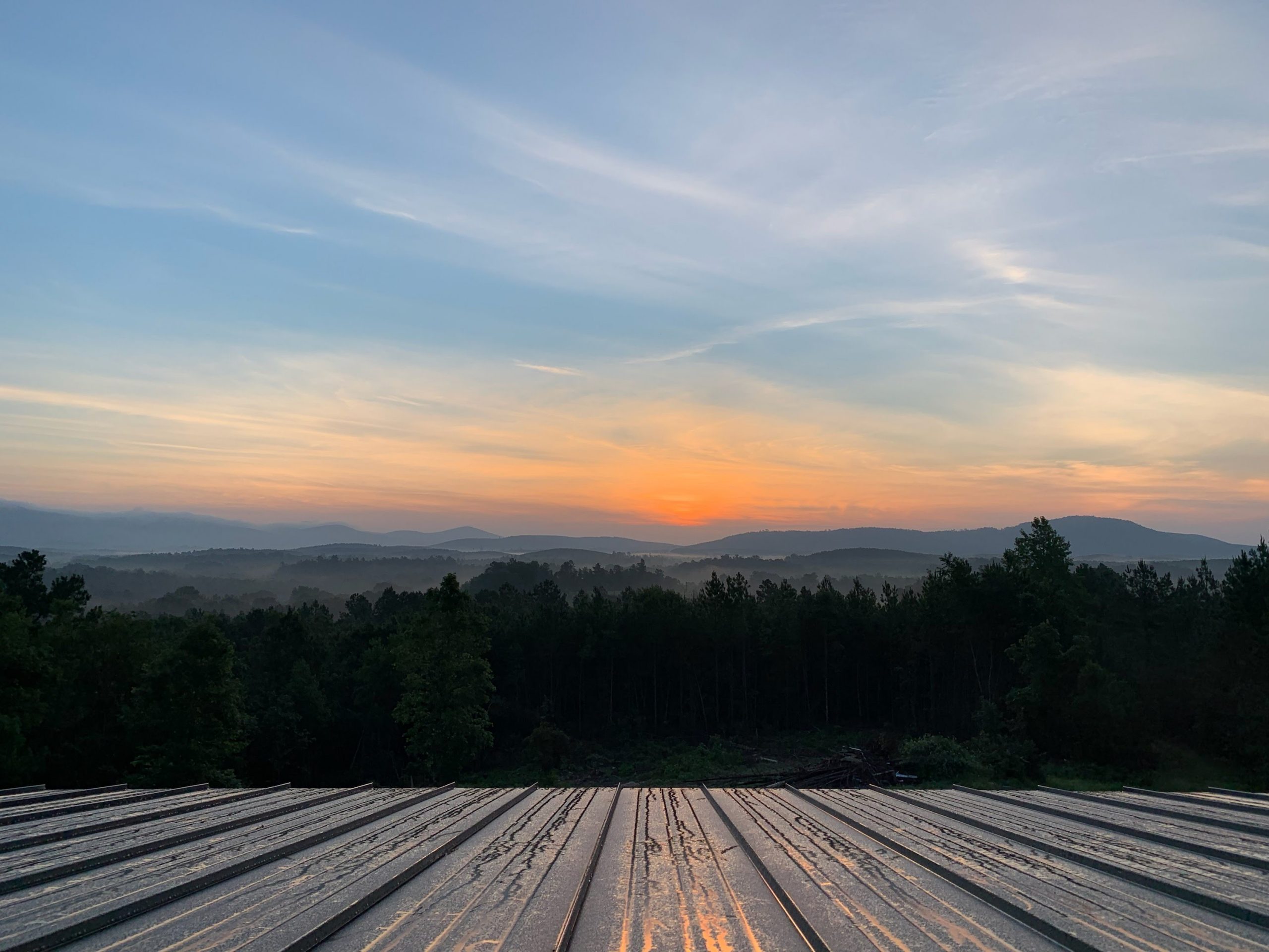 Sunrise over an Arkansas lake and wooded landscape